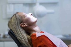 Woman awaiting treatment in a dental chair
