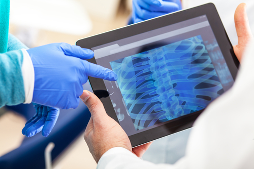 doctor sharing digital x-ray results with patient